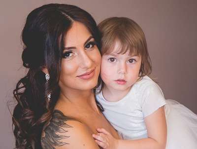 Woman with tattoo holding small child