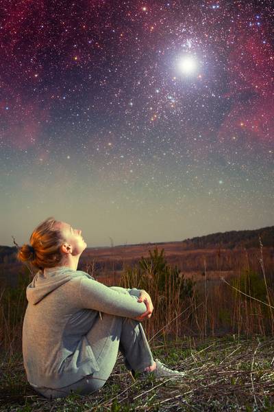 Modern girl gazing up at a star